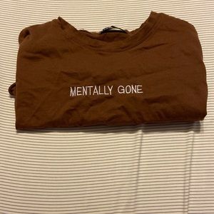 brown cropped top, says mentally gone